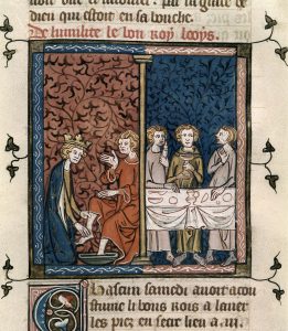 Miniature of St. Louis washing a poor man's feet and feeding the poor. From the British Library.